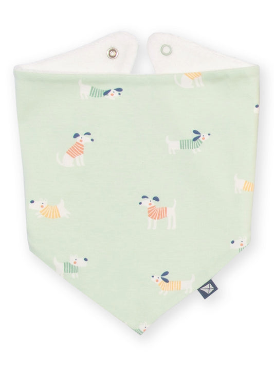 A pale mint green baby bandana bib with a playful pattern of small dogs wearing striped sweaters, featuring a white inner lining and metal snap closures at the top.