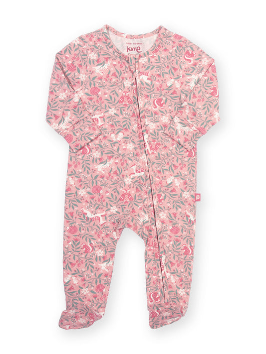 A baby footed sleeper in a pink and white floral print with green leaves, featuring a front zipper and long sleeves.