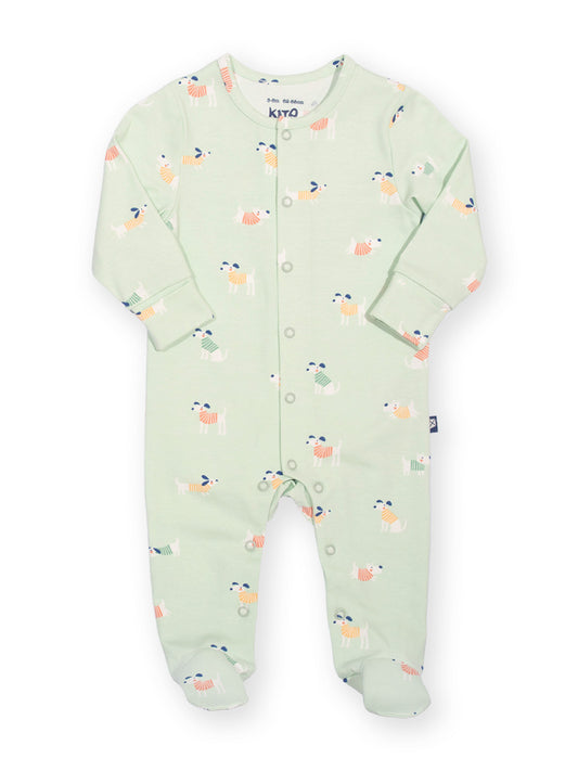 A baby long-sleeve footed sleeper in pale mint green with a colorful pattern of small cartoon animals, featuring snap buttons down the front. The brand name 'kito' is visible on the inner neck label.