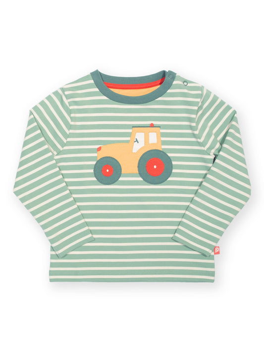 A long-sleeve baby t-shirt with light green and white horizontal stripes, featuring a cartoon tractor graphic on the chest with a yellow cab and red wheels.