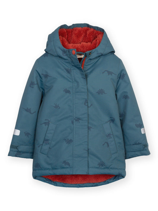A children's hooded winter jacket in slate blue with an allover dinosaur print, featuring a bright red fleece-lined hood and hem, displayed on a clean white background.