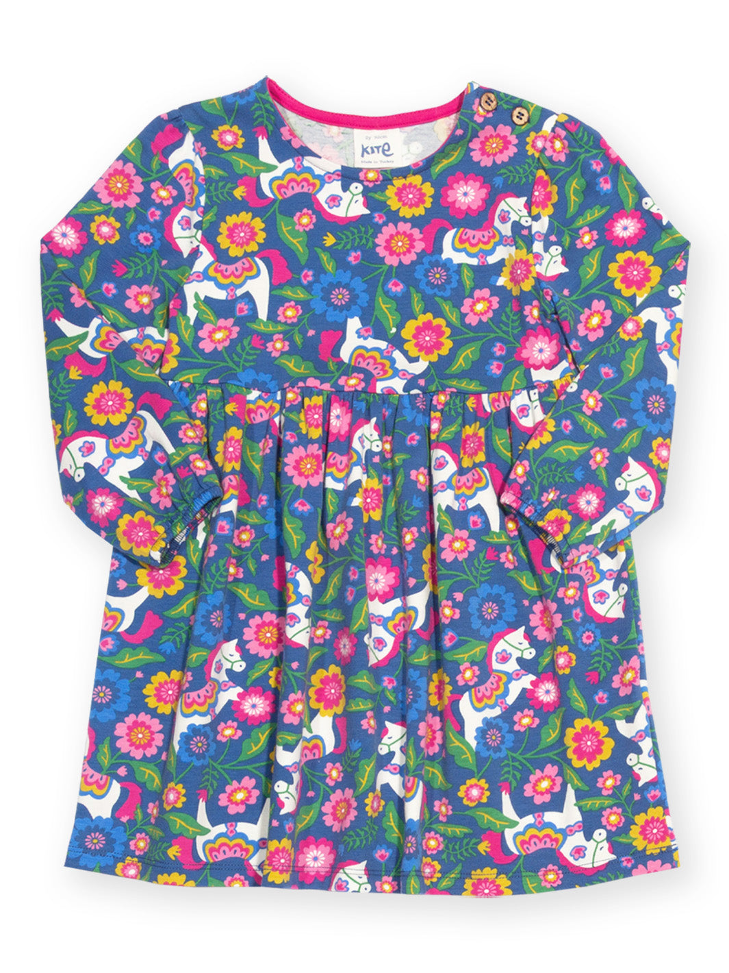 A long-sleeve children's dress with a vibrant, colorful print featuring white cats, pink and yellow flowers, and green leaves on a blue background. The brand name 'kng' is visible on the inner neck label.