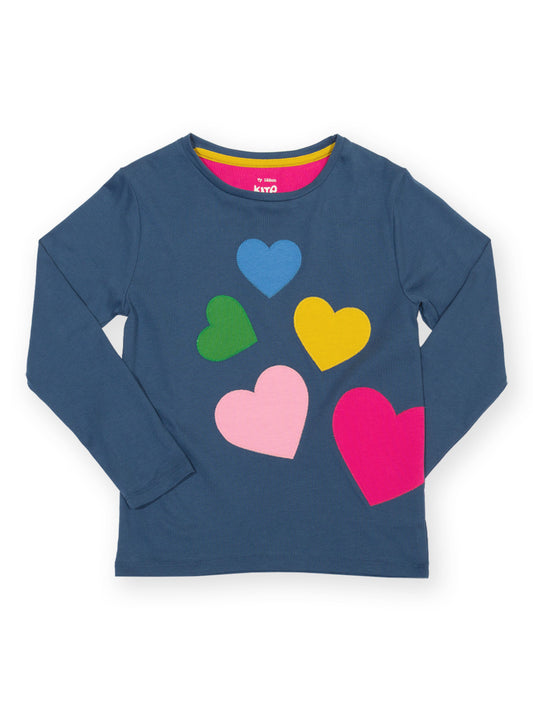 A navy blue long-sleeve t-shirt with a graphic print of five colorful hearts (blue, green, yellow, pink, and magenta) on the front, displayed on a clean white background.