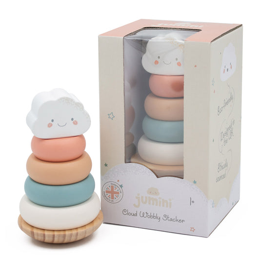 Stackable toy with cloud design next to its packaging on a white background