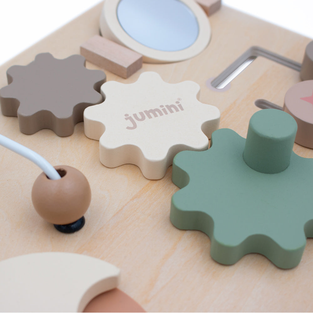 Children's wooden puzzle with gears and tools on a white background, featuring the brand 'jumini'.