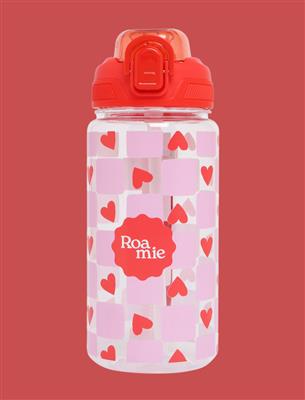 A clear plastic water bottle with a bright red flip-top lid, decorated with a pattern of light pink squares and red hearts. The center features a red scalloped label with the brand name 'Roamie' in white.