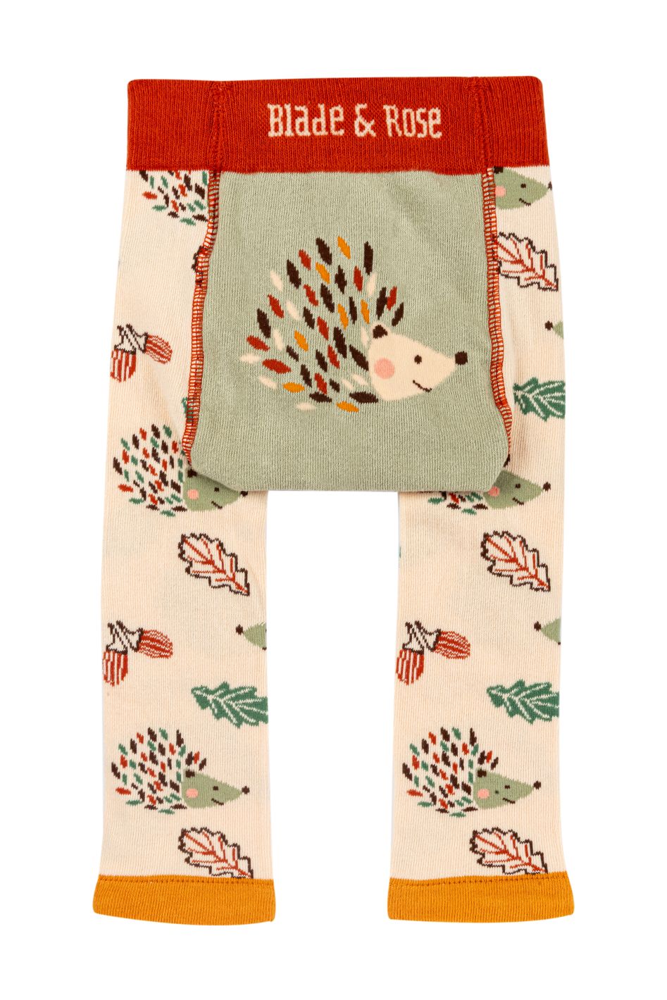 A pair of children's leggings by Blade & Rose, featuring a woodland hedgehog and autumn leaf pattern. The leggings have a cream base, a sage green central panel with a large embroidered hedgehog, a red waistband with the brand name 'Blade & Rose' in white, and orange/yellow cuffs.