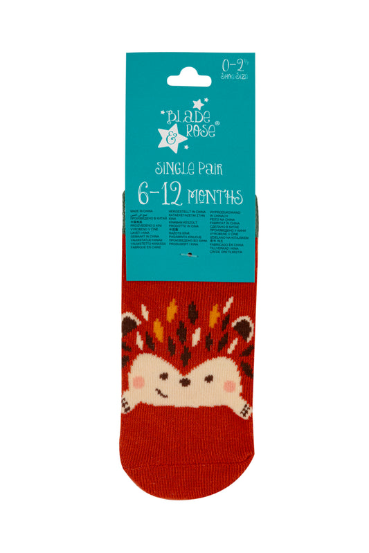 Children's sock with a fox design on a red background, featuring a blue packaging label.
